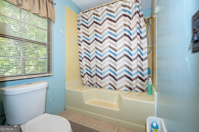 bathroom with shower / bath combo, tile patterned floors, and toilet