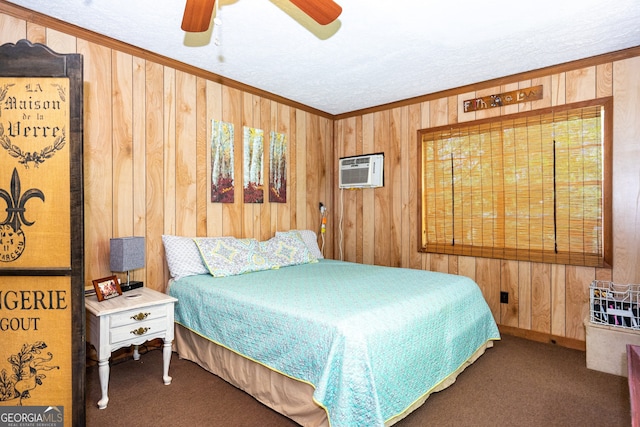 carpeted bedroom with ceiling fan, wooden walls, ornamental molding, and a wall mounted AC