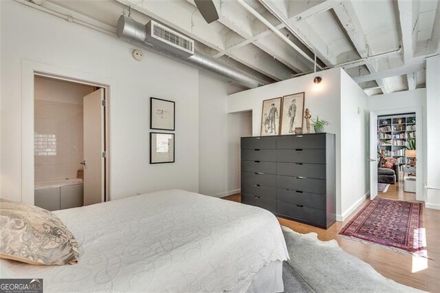 bedroom with ceiling fan, light wood-type flooring, and ensuite bathroom