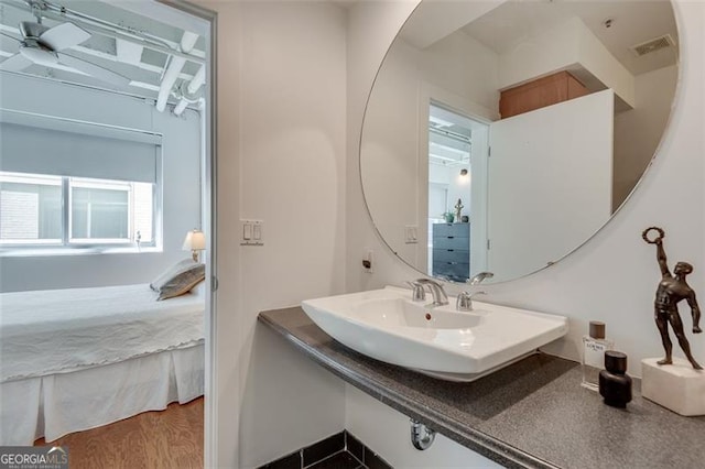 bathroom featuring ceiling fan, hardwood / wood-style flooring, and sink