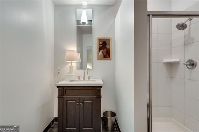 bathroom featuring vanity and a shower with shower door