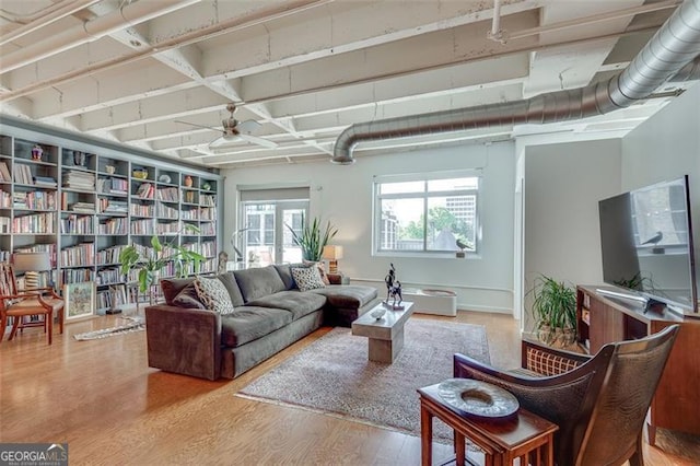 living room with ceiling fan and wood-type flooring