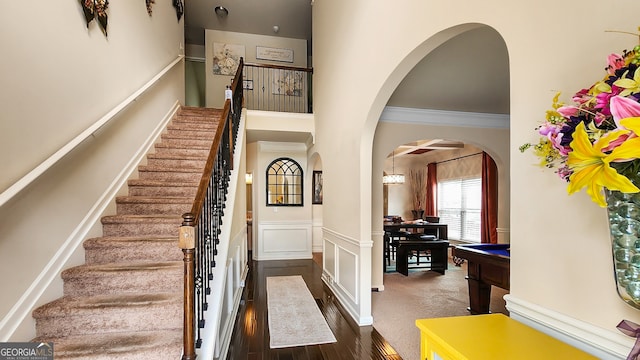 entryway featuring dark wood-type flooring and crown molding