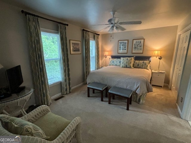 carpeted bedroom featuring a closet and ceiling fan