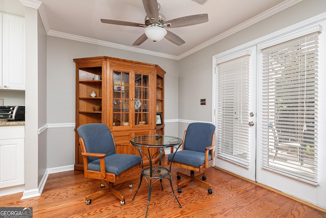 sitting room with light hardwood / wood-style floors, ceiling fan, and ornamental molding