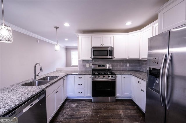 kitchen with pendant lighting, stainless steel appliances, white cabinetry, and sink