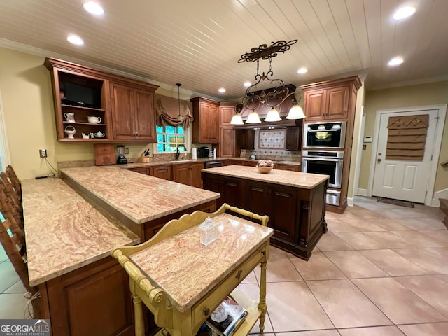 kitchen with kitchen peninsula, ornamental molding, a breakfast bar, a kitchen island, and hanging light fixtures