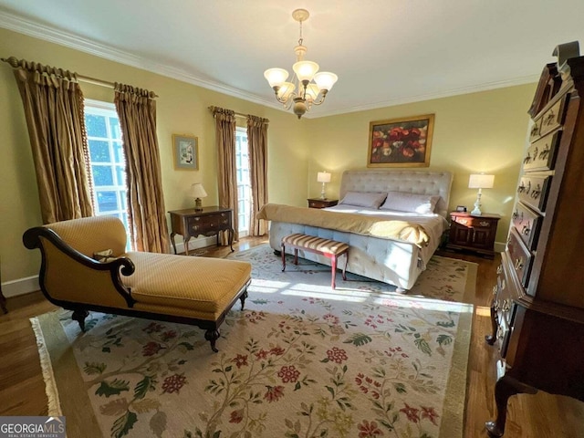 bedroom featuring hardwood / wood-style floors, a chandelier, and ornamental molding