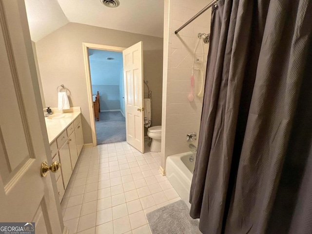 full bathroom with shower / bath combination with curtain, tile patterned floors, vanity, vaulted ceiling, and toilet