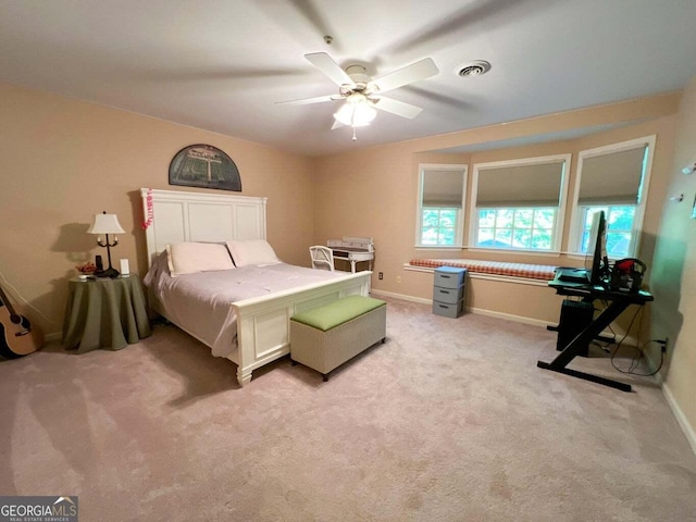 bedroom with ceiling fan and light carpet