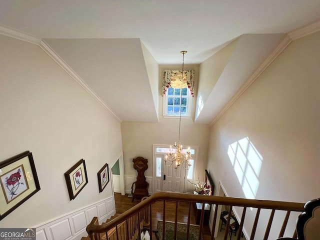 staircase featuring a towering ceiling and an inviting chandelier