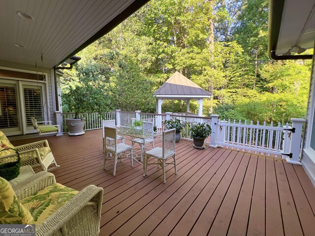 wooden terrace featuring a gazebo