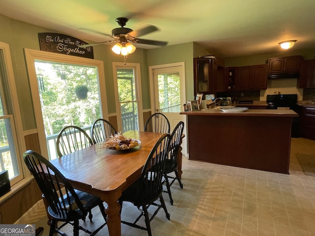 dining area with ceiling fan and sink