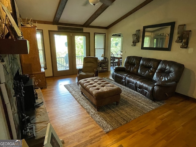 living room with wood-type flooring and vaulted ceiling with beams