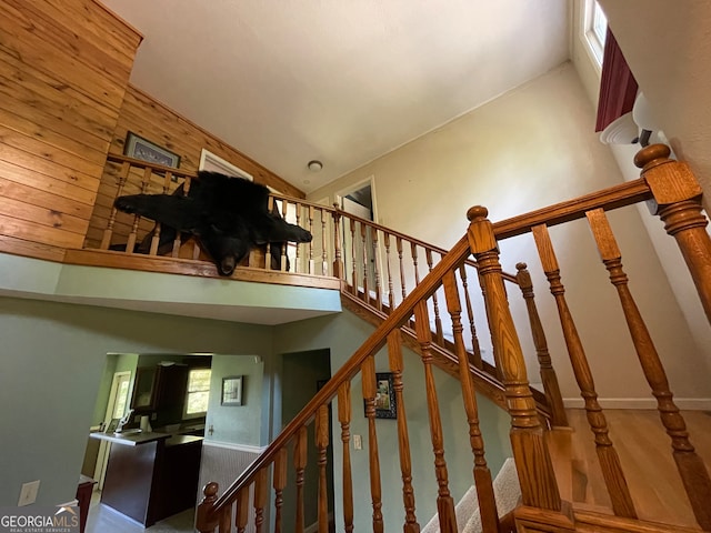 stairs featuring high vaulted ceiling