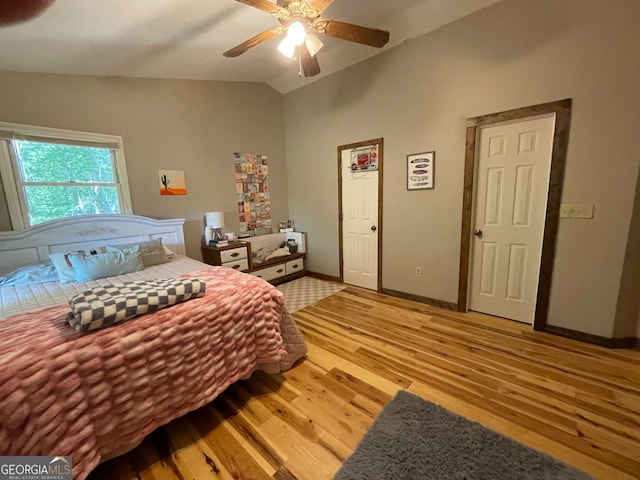 bedroom featuring light hardwood / wood-style flooring, lofted ceiling, and ceiling fan