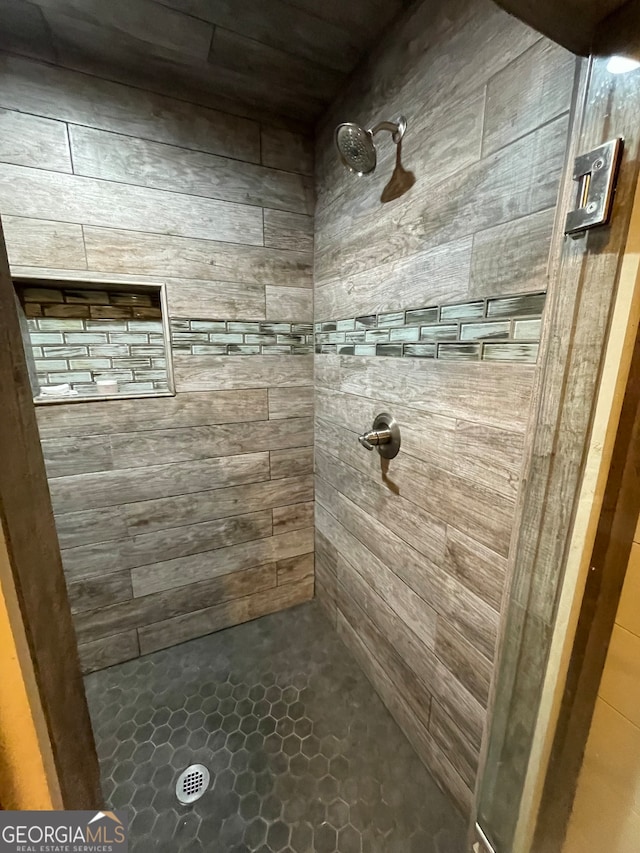 bathroom with tiled shower