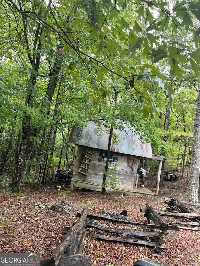 view of home's exterior with an outdoor structure