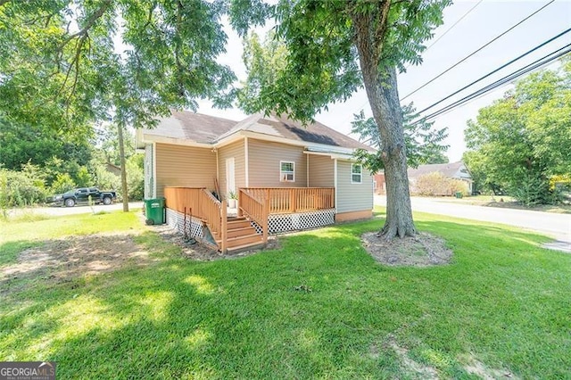 view of front of house featuring a front yard and a wooden deck