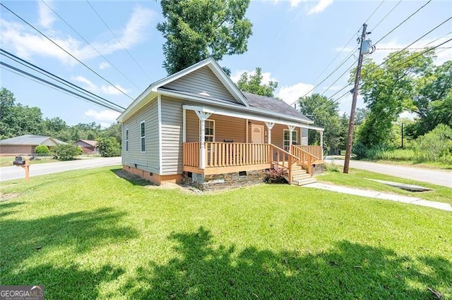 bungalow-style home featuring a front yard and covered porch