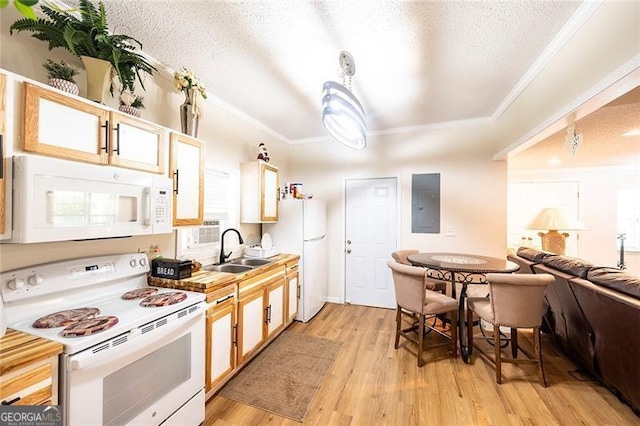 kitchen featuring light wood-type flooring, a textured ceiling, sink, white appliances, and ornamental molding