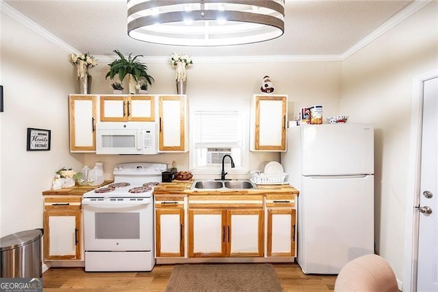 kitchen with ornamental molding, light hardwood / wood-style floors, sink, and white appliances