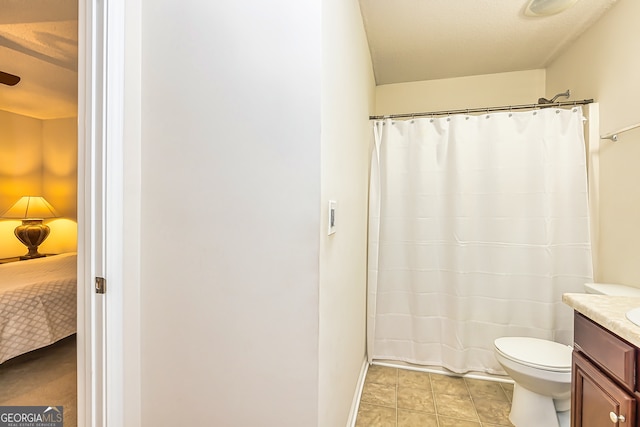 bathroom featuring walk in shower, vanity, and toilet