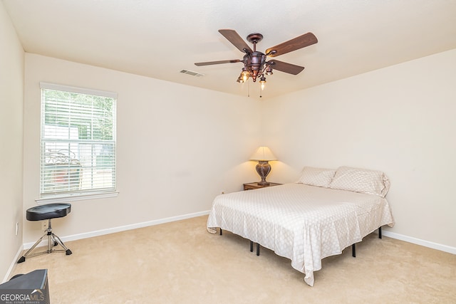 bedroom featuring light carpet and ceiling fan