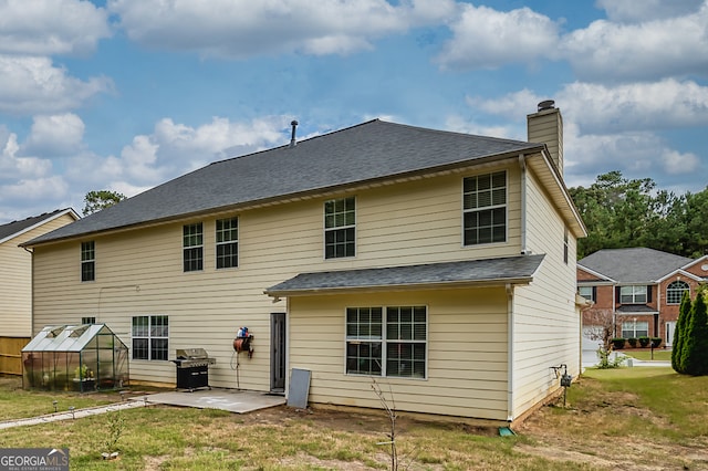 rear view of property with a patio area and a yard