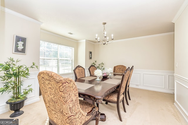 dining space with ornamental molding, light carpet, and a chandelier