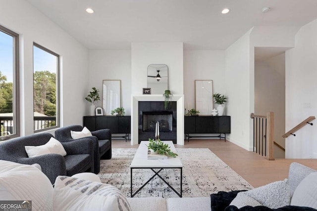 living room featuring light hardwood / wood-style floors and a tiled fireplace