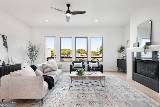 living room featuring light hardwood / wood-style floors and ceiling fan