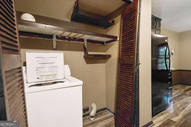 laundry room with washer / clothes dryer and hardwood / wood-style flooring