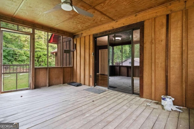 unfurnished sunroom featuring wooden ceiling, a healthy amount of sunlight, and ceiling fan