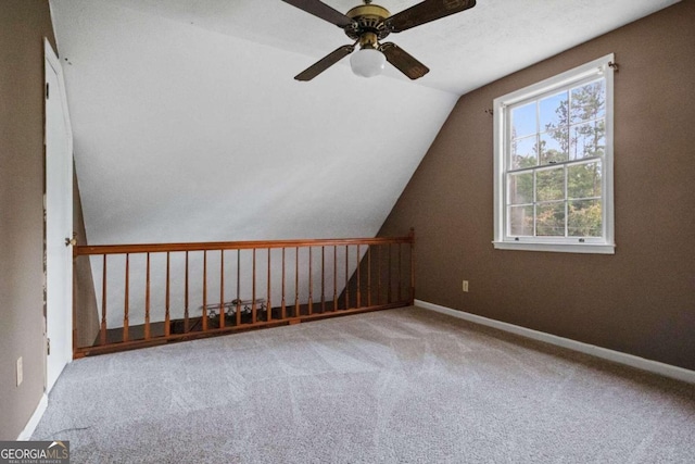 bonus room with light carpet, vaulted ceiling, and ceiling fan