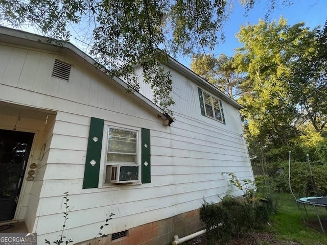 view of side of property with a trampoline