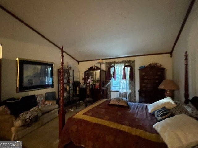 bedroom with ornamental molding and vaulted ceiling