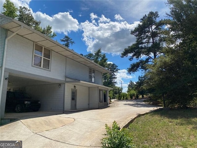 view of home's exterior featuring a carport