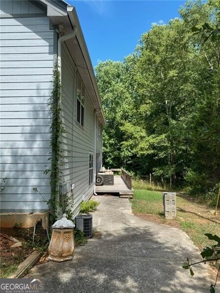 view of home's exterior featuring central AC unit and a patio area