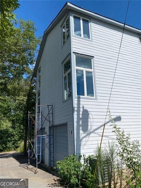 view of property exterior featuring a garage