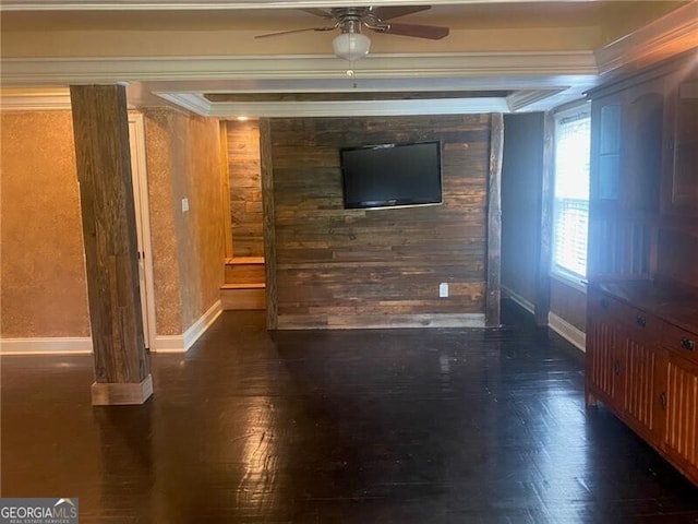 spare room with crown molding, wood walls, dark hardwood / wood-style floors, and ceiling fan