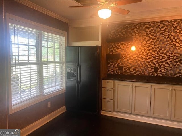 kitchen featuring ceiling fan, ornamental molding, tasteful backsplash, black fridge with ice dispenser, and white cabinetry