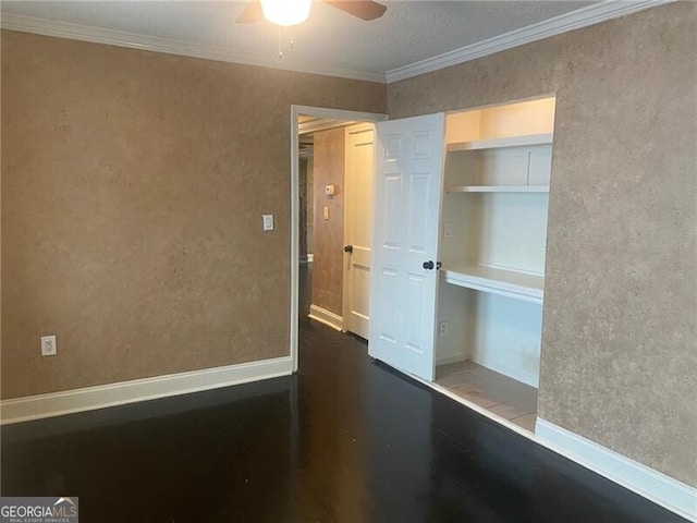 interior space with ceiling fan and ornamental molding