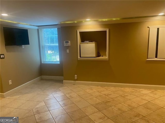 unfurnished room featuring crown molding