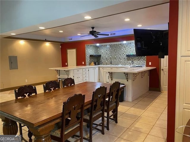 dining room featuring light tile patterned floors, electric panel, and ceiling fan