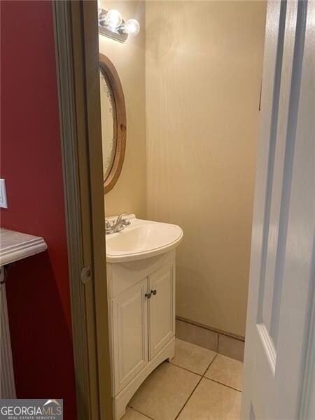 bathroom with tile patterned flooring and vanity