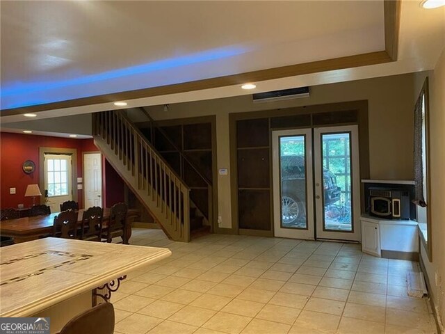 interior space with light tile patterned floors and a wood stove