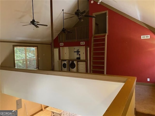 kitchen with high vaulted ceiling, ceiling fan, and separate washer and dryer