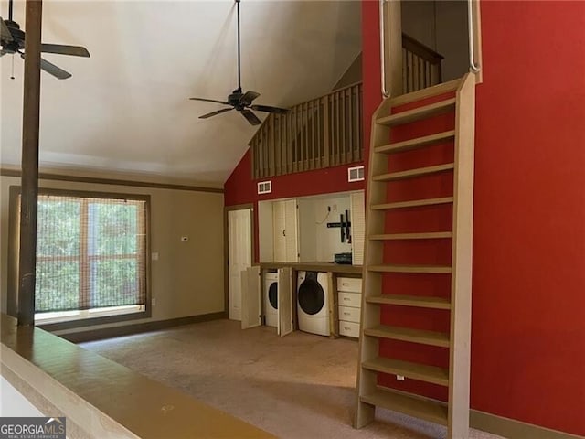 interior space with high vaulted ceiling, carpet, ceiling fan, and washer and clothes dryer