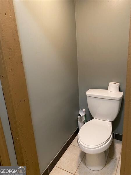 bathroom featuring tile patterned flooring and toilet